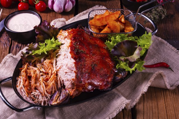 Delicious pulled pork with jacket potato quarters