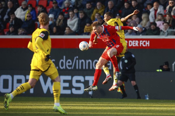 Germany: Soccer 1st Bundesliga, Matchday 20 - 1. FC Heidenheim vs. Borussia Dortmund - Voith-Arena Heidenheim: Captain Patrick MAINKA 1. FC Heidenheim left in aerial battle for the ball with Serhou GUIRASSY Borussia Dortmund for the ball, in the foreground Julian BRANDT Borussia Dortmund