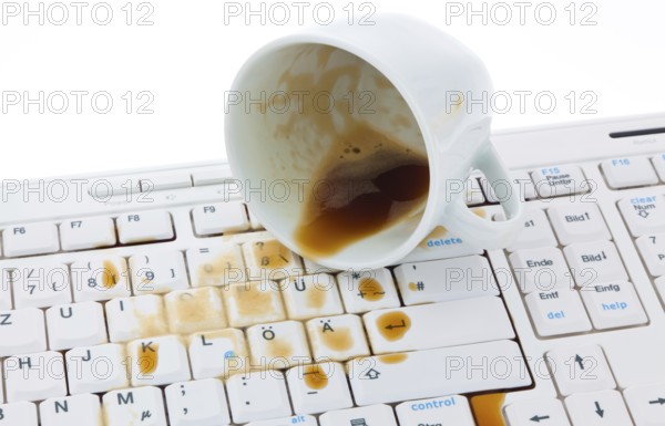 Coffee cup spilled on a computer keyboard. Damage for insurance company. Austria