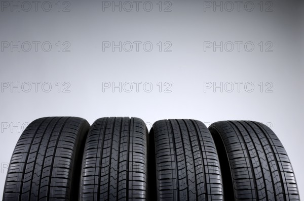 Set of all-season tires isolated on gray background
