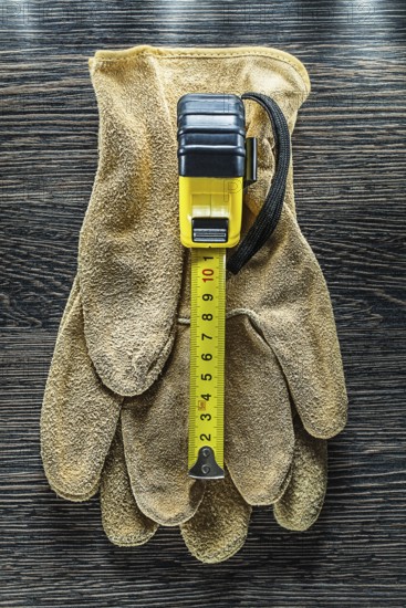 Tapeline safety gloves on wooden board