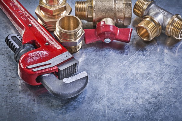 Monkey wrench brass plumbing fittings gate valve on metallic background