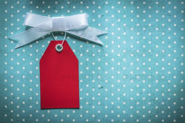 Sale tag on blue polka-dot tablecloth
