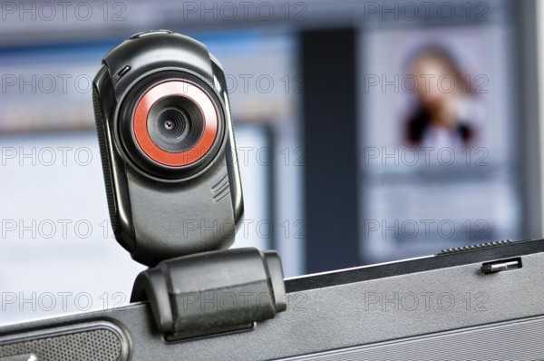 Webcam on monitor, in the background a screen with a portrait of a woman, Federal Republic of Germany