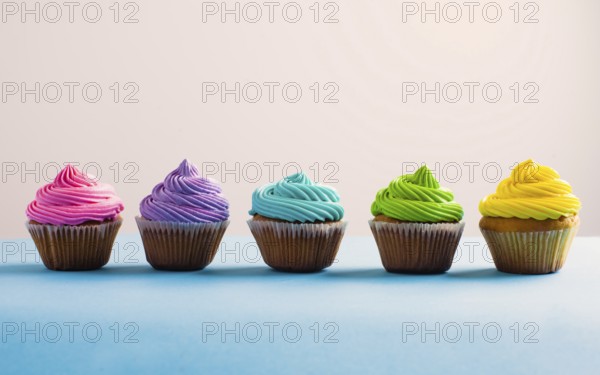 Vivid colous cupcake in a row. Different choices during the life