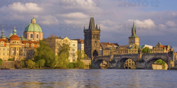 Charles Bridge (Karluv Most) on Vltava river and Old Town Bridge Tower, famous tourist destination in Prague, Czech Republic (Czechia), at sunset