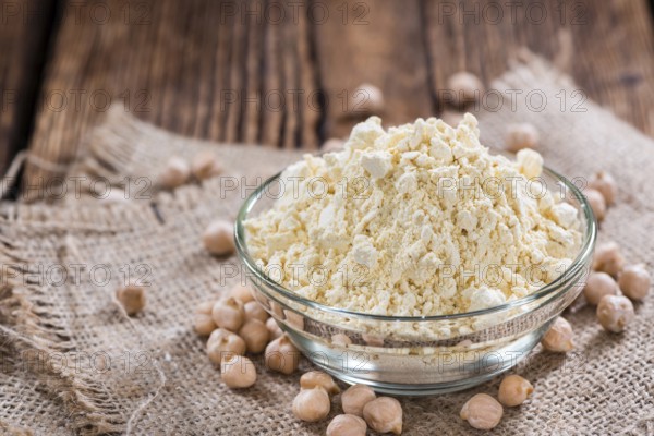 Chick Pea Flour on dark rustic background (close-up shot)