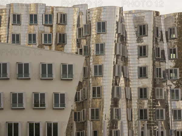 Detailed view of modern, distorted buildings with reflective facades and many windows, düsseldorf, North Rhine-Westphalia, germany