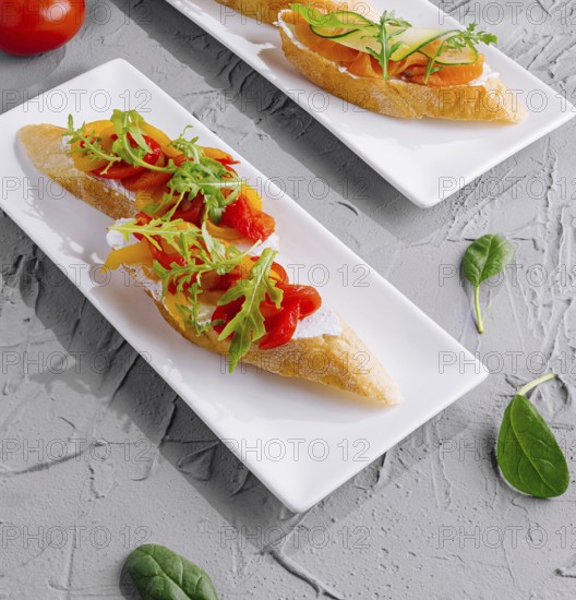 Food, Two plates of italian bruschetta with fresh tomatoes and arugula, ready to serve