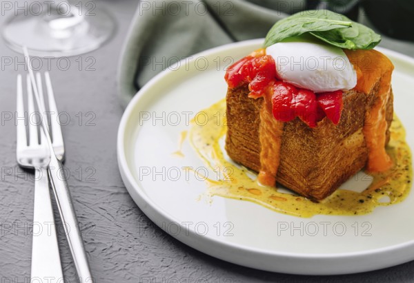 Food, Elegant brunch dish featuring a poached egg on top of french toast with a red pepper sauce