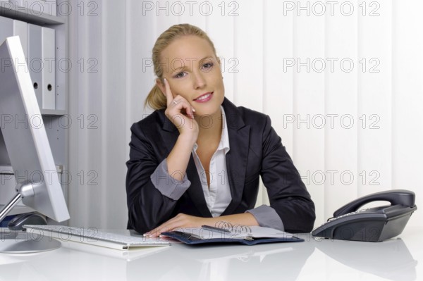 A secretary in the office at her daily work, 35 years, Thoughtful studio shot, Federal Republic of Germany