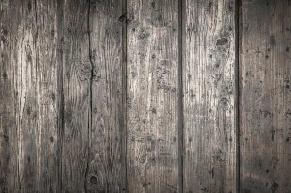 Rough wooden planks, dark and deteriorated by time