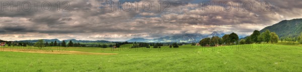 Panoramic picture in Allgäu / Bavaria with overcast sky in summer, panoramic composed from multiple images