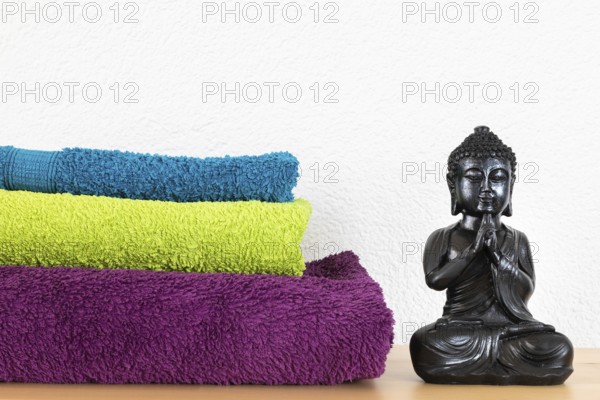An image of a Buddha figure and towels background