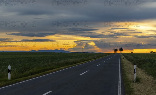 Sunset with long straight country road
