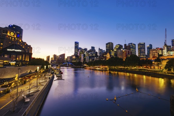 MELBOURNE, AUSTRALIA - OCTOBER 10, 2024: Melbourne skyline from Princes Bridge in Southbank along the Yarra River at dusk in Victoria, Australia