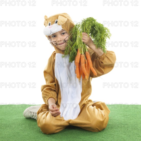Child dressed as easter hare with bunch carrots isolated over white background