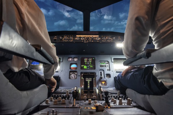 Pilots in the cockpit of an aircraft during a flight