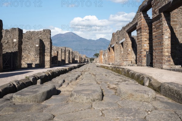 POMPEII, ITALY, MAY 04, 2022, A crosswalk of a typical Roman road in the ancient city of Pompeii, Southern Italy