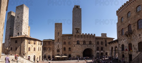 Main square Piazza del Duomo in San Gimignano with its famous palace towers, Italy
