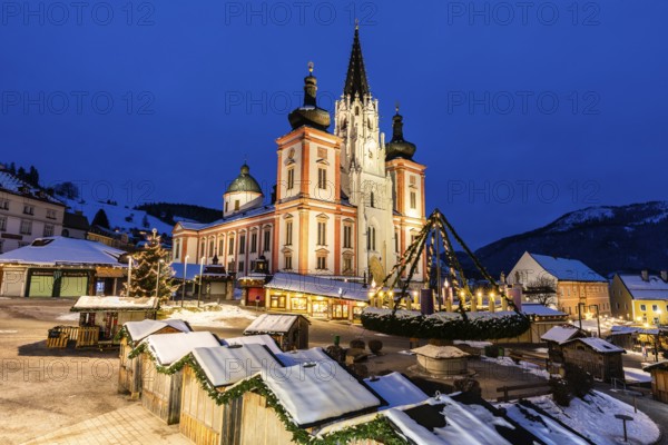 Advent atmosphere, world's largest hanging Advent wreath at the Christmas market in front of the basilica of Mariazell, blue hour in the early morning, Mariazell, Styria, Austria