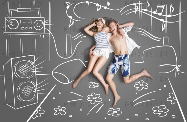 Love story of a romantic couple lying in bed, sharing headphones and listening to music against a backdrop of chalk drawings in a bedroom with an acoustic system