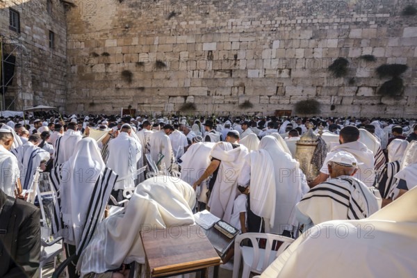 Blessing of the Cohenim in Passover. Jerusalem, Israel. Jews praying at the Western Wall wrapped in white Talit. Solemn celebratory ceremony at the Western slope of the Temple Mount. The concept of pilgrimage