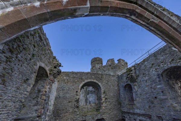 Conwy Castle, ruined stone walls and arch of the castle with a view of the sky, Conwy, Wales, Great Britain