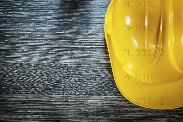 Safety building helmet on wooden board