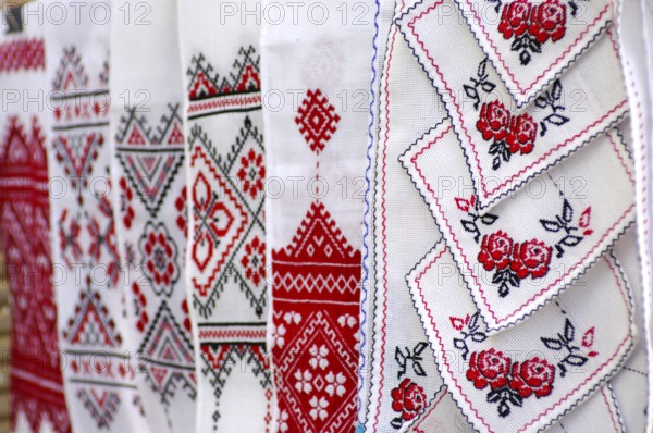 Stock photo of decorative towels with traditional Ukrainian folk national red and black embroidery patterns over white Kiev Ukraine Eastern Europe culture arts and crafts