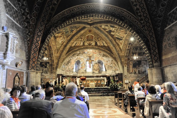 Basilica of St Francis of Assisi, Assisi, Umbria region, Italy, 1957, designed by Maestro Jacopo Tedescoa around 1253, Europe, Mystical church interior with frescoes and visitors contemplating, Umbria