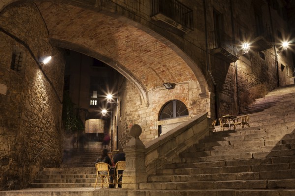 Arch of the Agullana Palace and Sant Domenec stairs at night in Girona, Catalonia, Spain