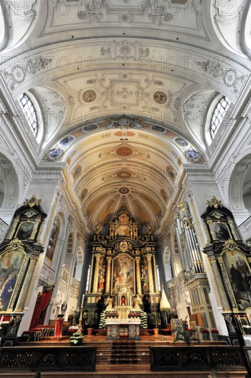 Interior view, central nave, Basilica and pilgrimage church of St. Anna, Altötting, Bavaria, Germany, Europe, Impressive baroque altar with elaborate ceiling decoration and sacred ambience, Chiemgau