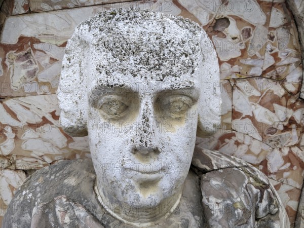 Weathered stone bust with classical features and detailed carving against a textured background, Villa Palagonia, known as the ‘villa of monsters', is an 18th-century walled building located in Bagheria, Sicily