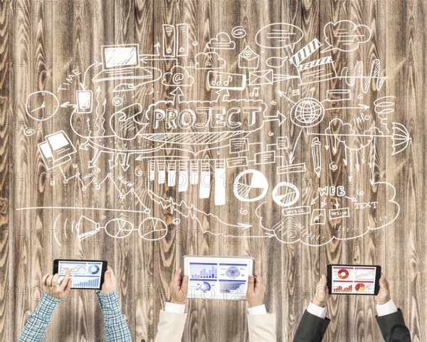 Group of three people with devices in hands working together as symbol of networking and communication