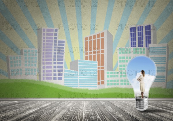 Businesswoman inside light bulb against city drawn concept