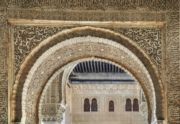 Arch with stone relief with arabesques in Alhambra palace, Spain