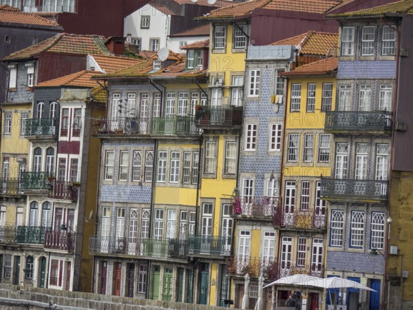 Row of multi-storey, colourful houses with ornate balconies and historic charm, porto, portugal