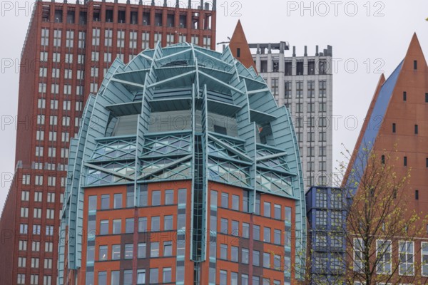 Detailed view of a modern skyscraper with a unique design, surrounded by other buildings in The Hague, The Hague, Netherlands