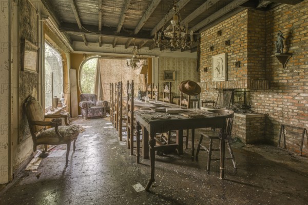 A dining room in an abandoned state, with an empty table and scattered chairs, Maison Limmi, Lost Place, Kalken, Laarne, Province of East Flanders, Belgium