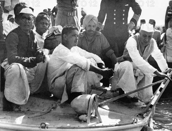 Jawaharlal Nehru Devdas Gandhi and Ramdas Gandhi holding the urn on boat to confluence of rivers Ganges, Yamuna and Saraswati, February 12, 1948 NO MR