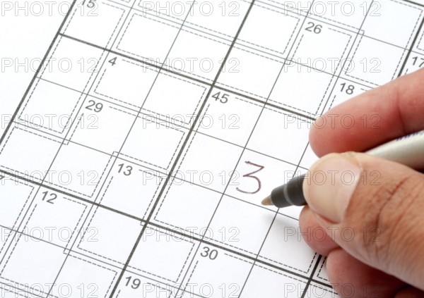Solving a Crossword Puzzle with human hand writing a number