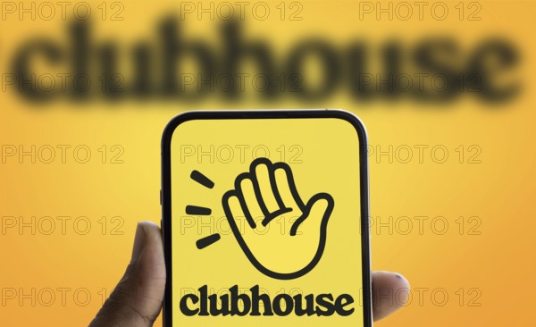Clubhouse logo is displayed on smartphone. Clubhouse is a social audio app for iOS and Android.