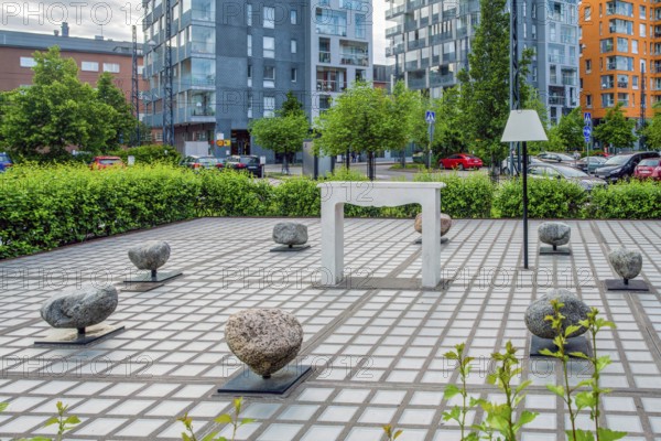 06-22-2022 Helsinki Finland a playground next to the house on which a seat in the form of rotating (!) stones and a lamp (floor lamp) for lighting at night in Arabianranta district