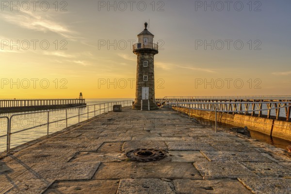 Golden Hour at the East Pier and Whitby East Harbour Lighthouse in Whitby, North Yorkshire, England, UK
