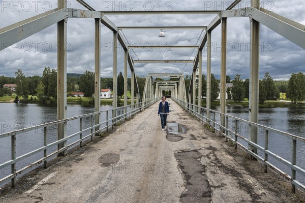 Sweden, 08 03 2019: Woman walking over the Milleniumbridge