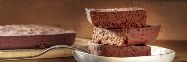 Chocolate brownie panorama, simple coffee cake, a side view shot on a dark rustic wooden background, Food photography, Food photography