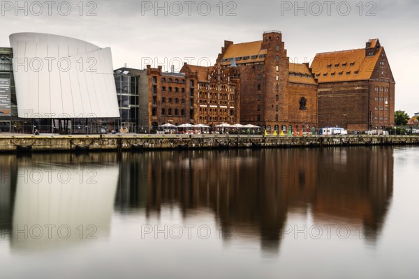Stralsund, Germany, August 1, 2019: Scenic view of the harbour and the Ozeaneum aquarium in Stralsund. Long exposure view at sunrise with reflection on water