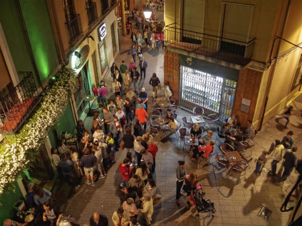 People of all ages enjoy a a party on the Torres de Omana Square on a mild autumn evening, Leon, Castile and Leon, Spain