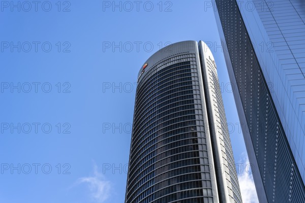 Madrid, Spain, May 10, 2020: Low angle view of office building in the city of Madrid against blue sky. PWC building in Cuatro Torres financial district